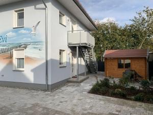 a mural on the side of a building with a balcony at Villa Evi Modern retreat in Lubmin