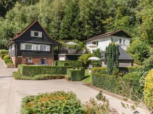 a house with a yard with bushes and trees at Panorama Modern retreat in Eslohe