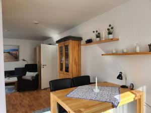 een woonkamer met een tafel en een eetkamer bij Sound of the sea Modern retreat in Wangerooge