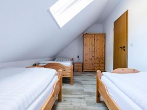 A bed or beds in a room at Am Wald Modern retreat