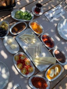 a table with many plates of food on it at Mare Deluxe Residences & Villas in Gundogan