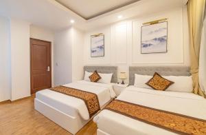 Bảo Duy 4 Hotel tesisinde bir odada yatak veya yataklar