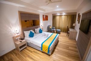 a hotel room with a bed and a living room at Arcadia Hotel in Varanasi