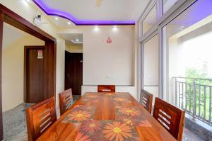 a dining room with a long table and chairs at Anchorage Inn in Thākurdwari