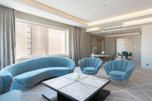a waiting room with blue chairs and a table at Crowne Plaza Hotel Riyadh Minhal, an IHG Hotel in Riyadh