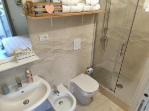 a bathroom with a shower and a toilet and a sink at l'alba sullo jonio in Taranto