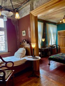 a bedroom with a bed and a table with a lamp at norddeutscher Hof - Kutscherstation in Usedom Town