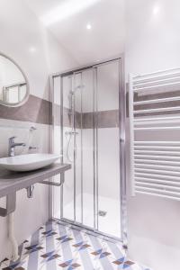 a bathroom with a shower and a sink at Hotel Jenner in Paris
