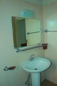 a bathroom with a white sink and a mirror at Mount Heaven Hotel Murree in Murree