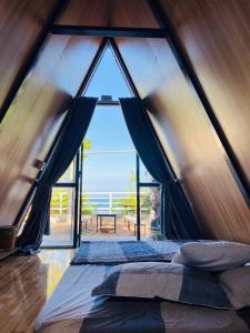 a bedroom with a large window in a tent at Kaktus home & kafe in Tuy Hoa
