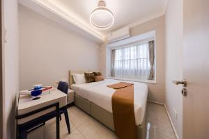 Giường trong phòng chung tại Xi Ke Executive Apartment - Shenzhen Futian Exhibition Center