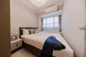 Giường trong phòng chung tại Xi Ke Executive Apartment - Shenzhen Futian Exhibition Center