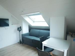 a room with a couch and a table and a window at Villa Cathy Studio in Aix-les-Bains