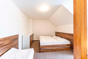 a bedroom with two beds in a attic at Apartmany Kouty in Loučná nad Desnou