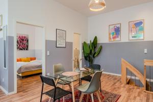 a living room with a glass table and chairs at Spacious, central 3 room flat with gym & play area in Berlin