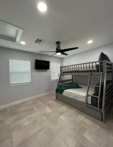 a bedroom with a bunk bed and a ceiling fan at NEW! Private Lux Home Near Airport, Affordable AZ in Phoenix +28 photos