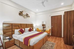 a bedroom with a large bed and a desk at Amahi Inn in Gurgaon