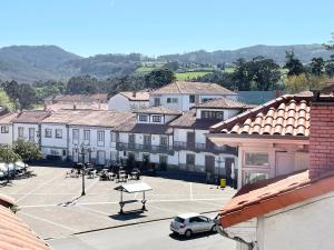 a parking lot with a basketball court in a town at La Casa de los Libros in Muros de Nalón