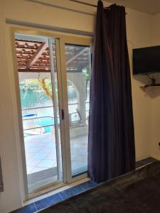 a sliding glass door with a view of a pool at Villa Agata in Lastovo
