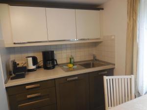 a kitchen with a sink and a counter top at Ferienhaus Vorwachs 1 in Schwielochsee +8 photos