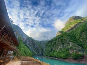 a view of a river between two mountains at Riverside Komani Lake in Koman