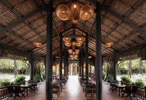 a pavilion with tables and chairs and a chandelier at Phuong Nam Resort in Thuan An