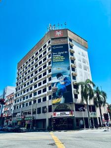 a building with an advertisement on the side of it at Hotel Yt Midtown Kuala Terengganu in Kuala Terengganu