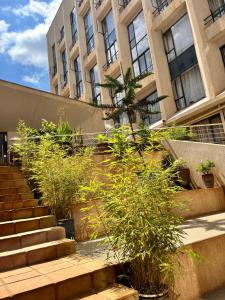 a set of stairs in front of a building with plants at JoJo Jovial Homes in Kiambu