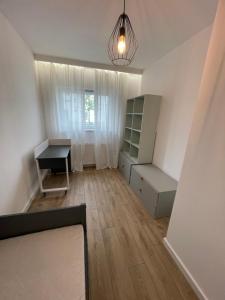 an empty room with a desk and a table at Marcelin Business & Family in Poznań