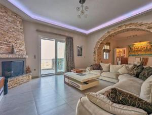 a living room with a couch and a fireplace at BELLAVISTA HOUSE in Sifnos