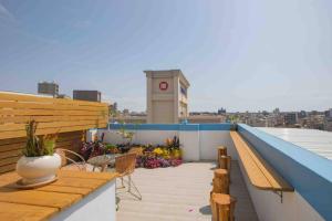 a balcony with a clock tower on top of a building at Xianwang Homestay in Jincheng