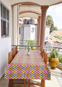a table with a colorful table cloth on a balcony at OMX Hotel Remera in Kigali