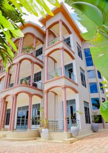 a large white building with balconies on it at OMX Hotel Remera in Kigali