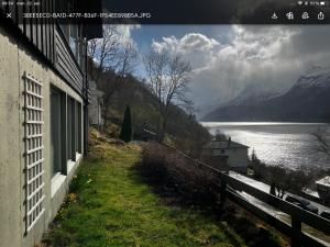 a house with a view of a lake and mountains at Fjordview 35 in Lofthus