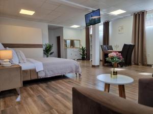a hotel room with a bed and a living room at Studio Aurora Blue in Eforie Sud