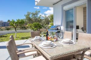 a dining table and chairs on a patio at Sunny Villa in Faliraki