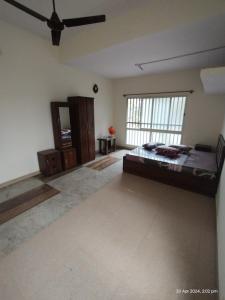 a bedroom with a large bed and a large window at GM Comforts -LODGE-CL-7 in Bangalore