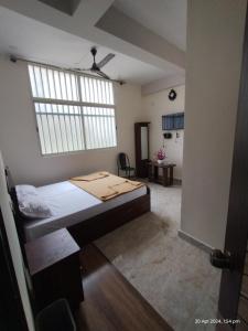 a bedroom with a bed and a large window at GM Comforts -LODGE-CL-7 in Bangalore