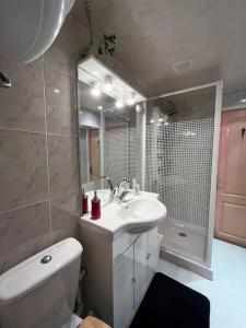 a bathroom with a sink and a toilet and a shower at Maison de charme - proche toutes commodités in Marseillan +20 photos