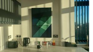 a kitchen with a counter top with a painting on the wall at Stunning one bedroom near Old Trafford Stadium in Manchester +16 photos