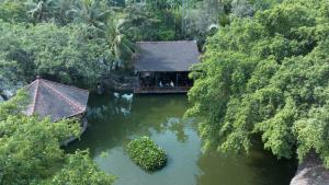 an aerial view of a house in the middle of a river at Phuong Nam Resort in Thuan An