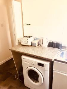 a kitchen with a washing machine on a counter at Inverthorn House in Inverness