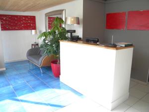 a lobby with a reception desk and a couch at HOTEL GENOVA in Scalea