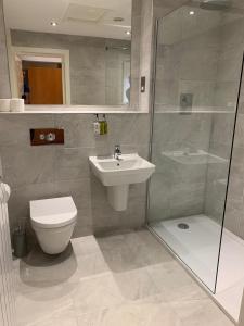 a bathroom with a toilet and a sink and a shower at Hedley House Hotel & Apartments in York
