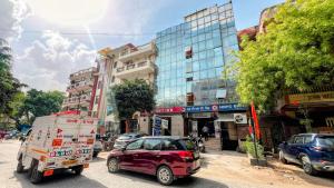 a car is pulling a cart on a city street at Hotel Jashn Inn near Apollo Hospital in New Delhi