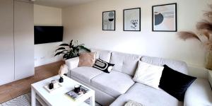a living room with a couch and a table at Przytulny Apartament - Centrum in Piaseczno