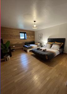 a large bedroom with two beds and a table at Espace cocooning 
