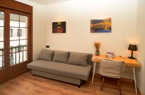 a living room with a couch and a desk at Hotel A Reigada in Grandas de Salime