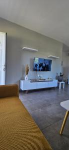 a living room with a tv on the wall at heaven suite elafonisi in Elafonisi
