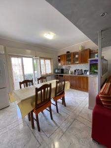 a kitchen with a table and chairs in a kitchen at Tyttyhouse in Giardini Naxos +8 photos